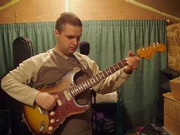 Picture of Phil playing a 1970's Fender Stratocaster in his studio